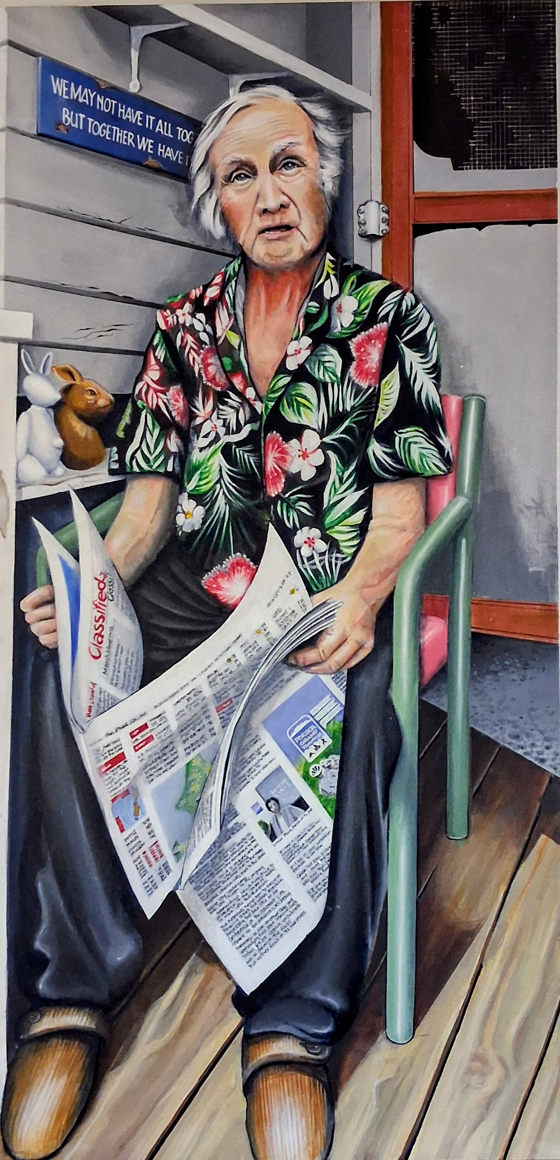 Portrait of an older woman seated with newspapers